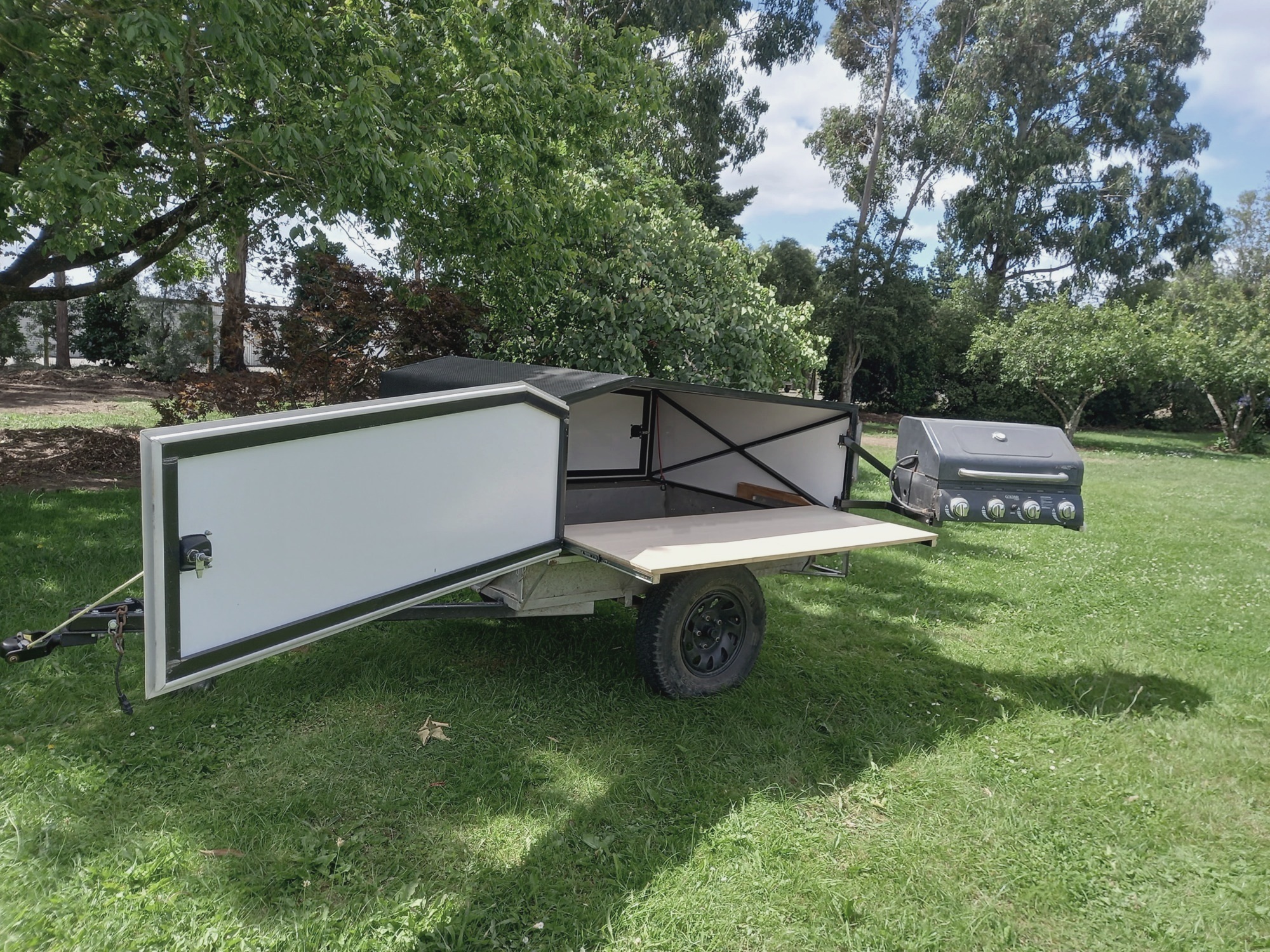 Second BBQ trailer opened with its barbecue and work surfaces