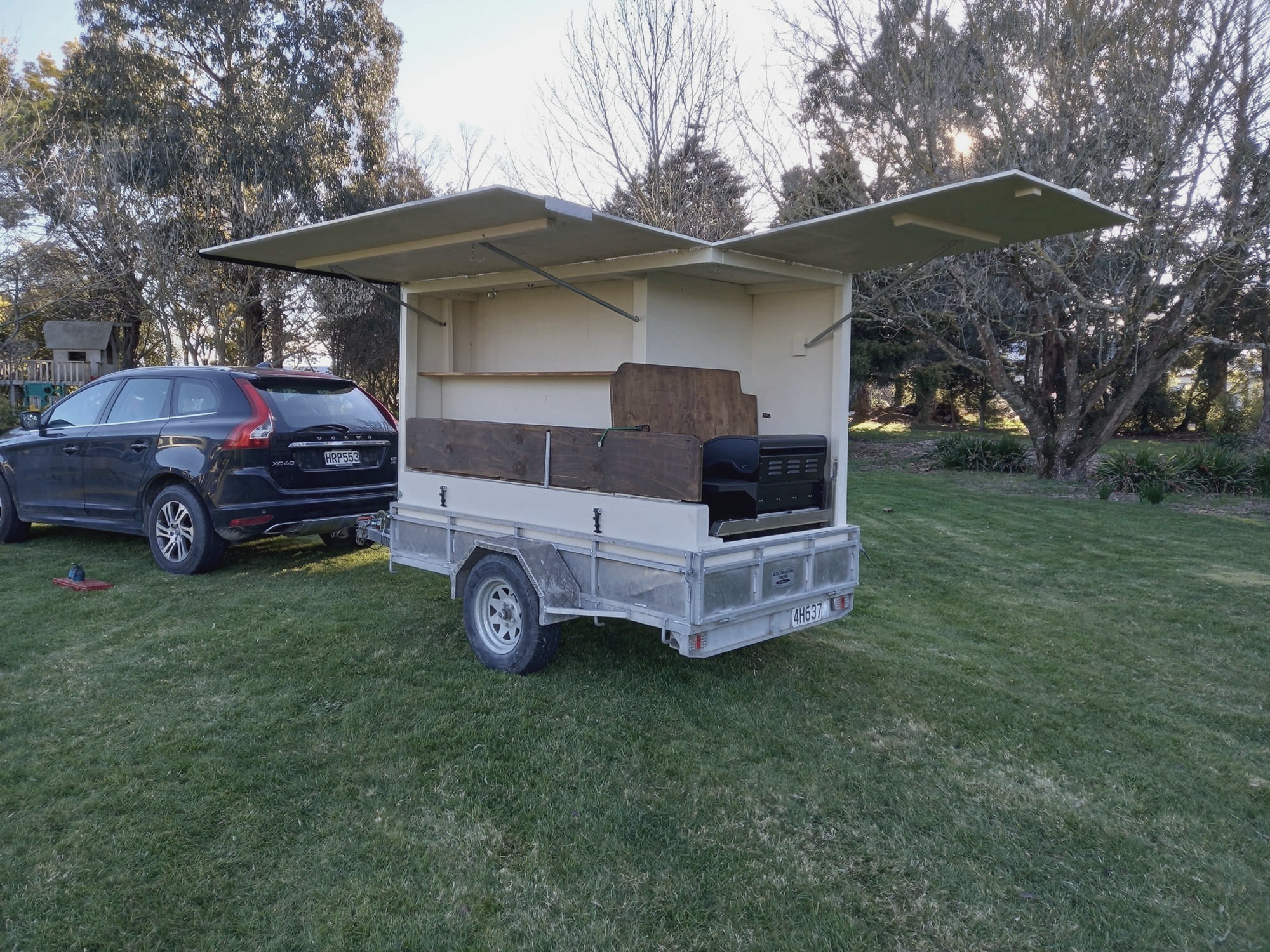 First white BBQ trailer with its doors open