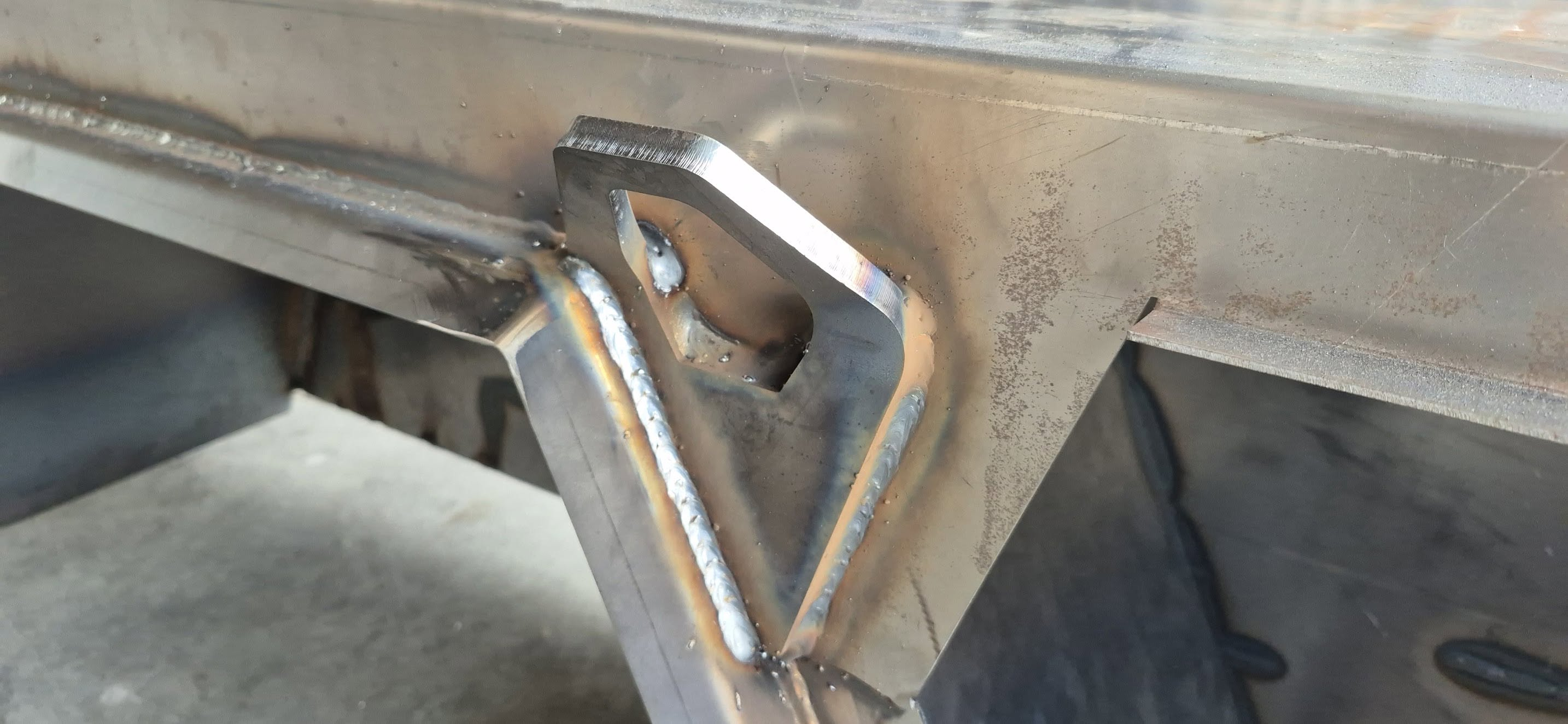 Close-up of welds around a steel mounting lug